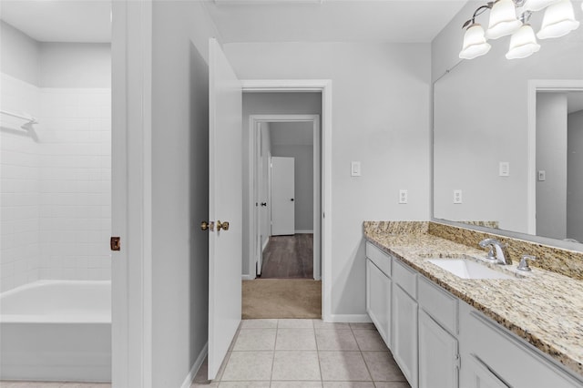 bathroom with tile patterned flooring, baseboards, washtub / shower combination, a chandelier, and vanity