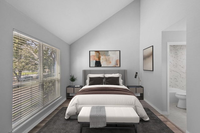 bedroom with connected bathroom, baseboards, lofted ceiling, and wood finished floors