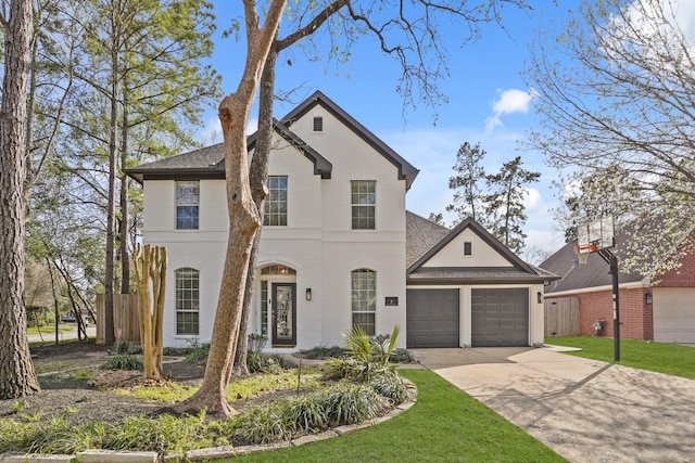 view of front of property with a front yard, fence, driveway, roof with shingles, and an attached garage