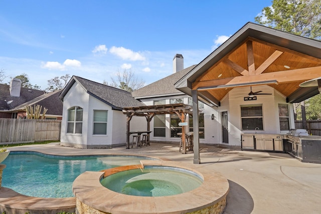 view of pool featuring a patio, exterior kitchen, a fenced backyard, a pergola, and a grill