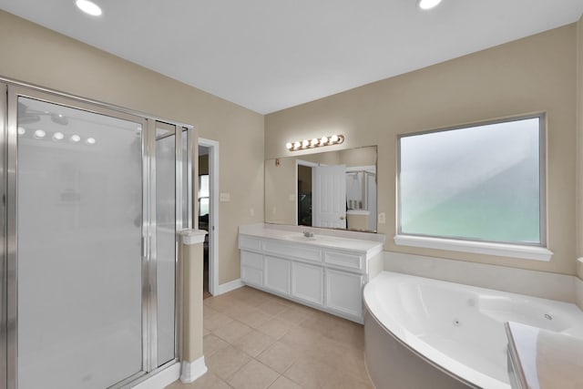 bathroom featuring vanity, baseboards, a stall shower, tile patterned flooring, and a jetted tub