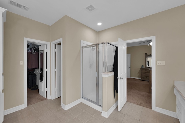 bathroom with vanity, a shower stall, and visible vents