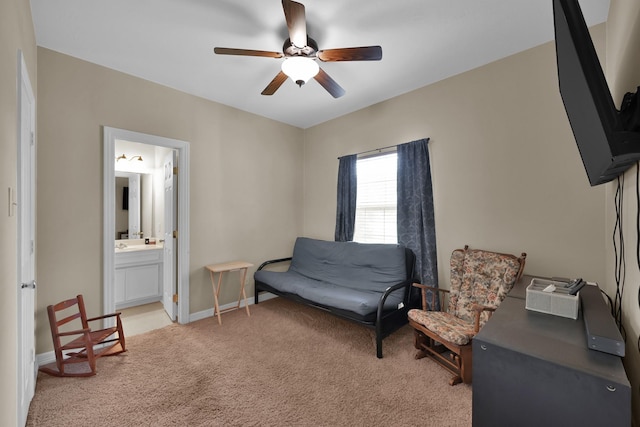 living area featuring baseboards, light colored carpet, and ceiling fan