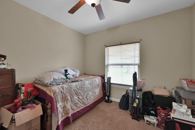 carpeted bedroom featuring baseboards and ceiling fan