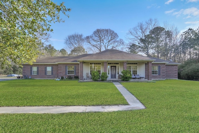 ranch-style home featuring brick siding and a front yard