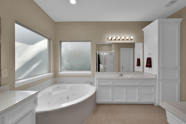 full bathroom featuring tile patterned flooring, vanity, visible vents, and a whirlpool tub