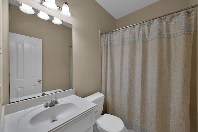 bathroom featuring toilet and vanity