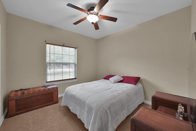 carpeted bedroom featuring a ceiling fan and baseboards