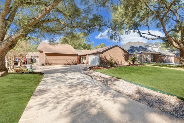 view of front of home with brick siding, a front lawn, concrete driveway, and an attached garage