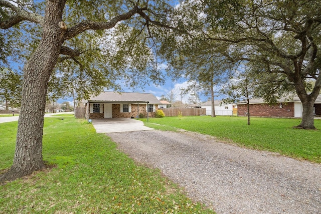 single story home featuring a front yard, brick siding, driveway, and fence