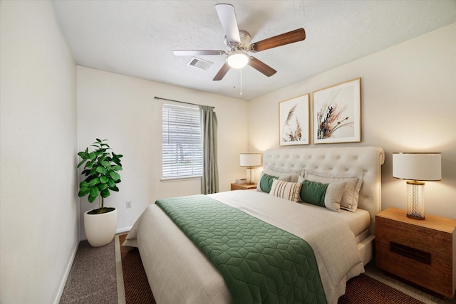 bedroom featuring ceiling fan, carpet, visible vents, and baseboards