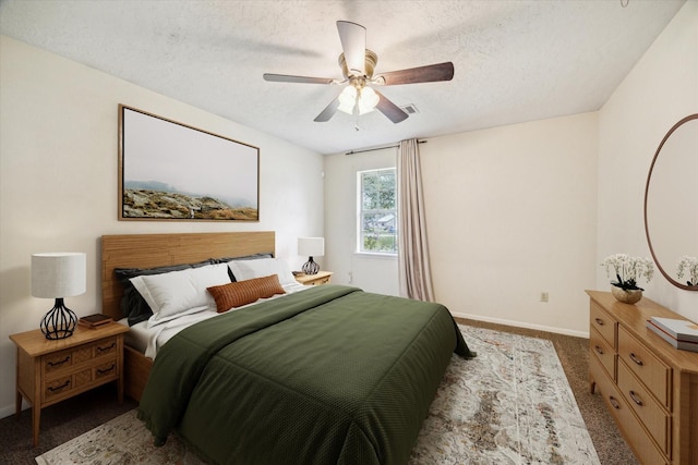 bedroom featuring visible vents, baseboards, ceiling fan, a textured ceiling, and carpet flooring