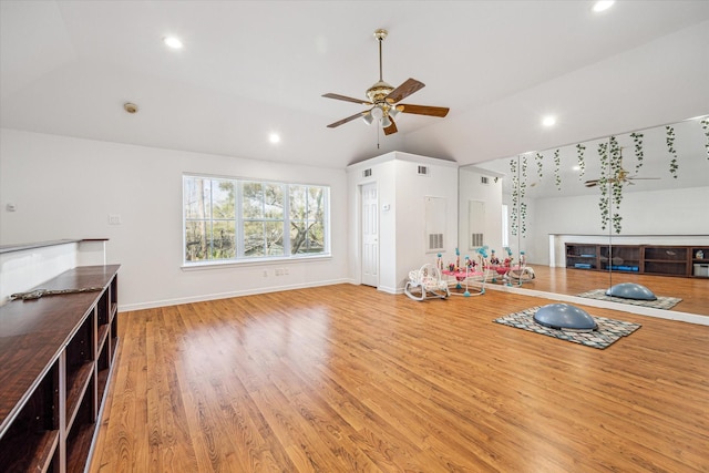 interior space with a ceiling fan, wood finished floors, recessed lighting, baseboards, and vaulted ceiling