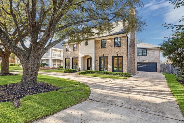 view of front of house with fence, concrete driveway, a front lawn, a garage, and brick siding