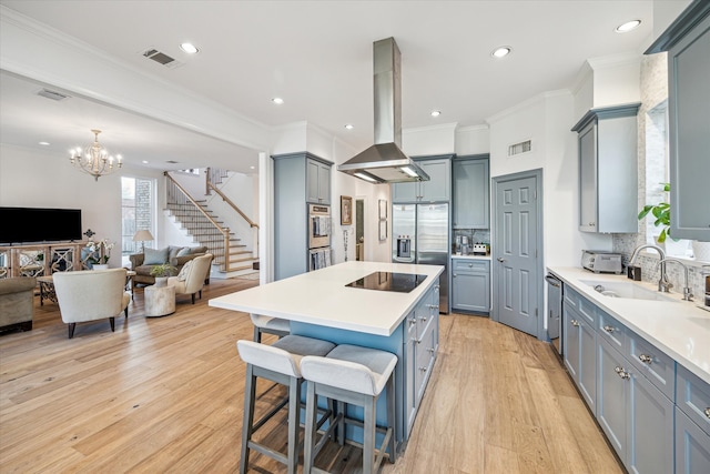 kitchen featuring visible vents, open floor plan, gray cabinets, appliances with stainless steel finishes, and island exhaust hood