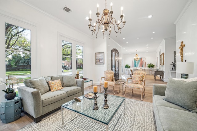 living room with visible vents, ornamental molding, light wood-style flooring, recessed lighting, and a chandelier