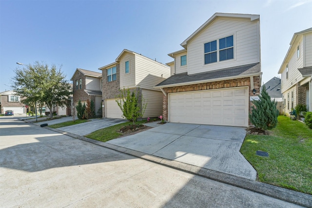 view of front of property featuring a garage, a residential view, a front yard, and driveway