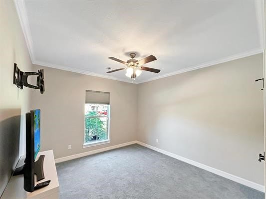 interior space featuring carpet flooring, baseboards, ceiling fan, and crown molding