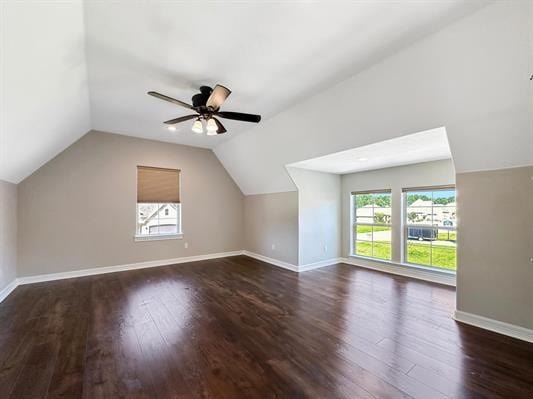 bonus room featuring dark wood-style floors, baseboards, lofted ceiling, and a ceiling fan