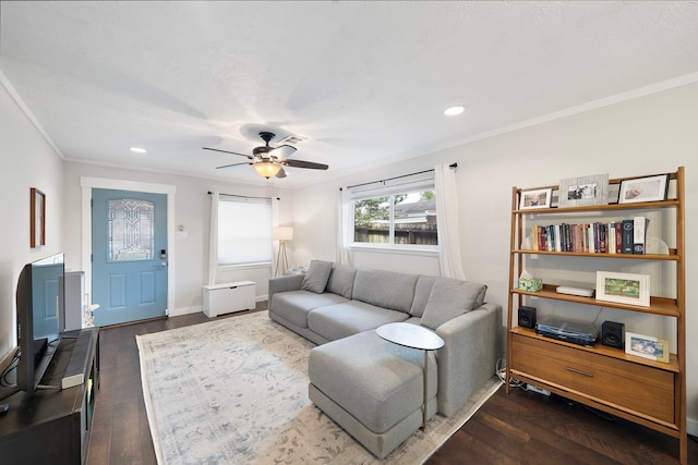 living area featuring crown molding, ceiling fan, dark wood-type flooring, baseboards, and recessed lighting