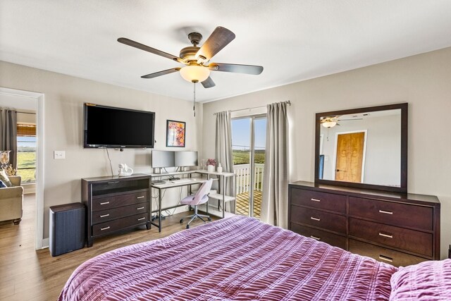 bedroom featuring ceiling fan, wood finished floors, and access to outside