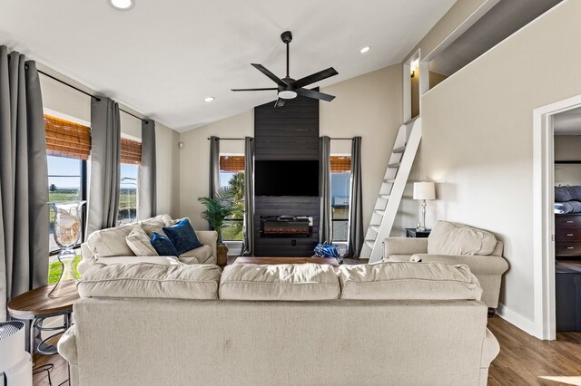 living room featuring ceiling fan, lofted ceiling, recessed lighting, a fireplace, and wood finished floors