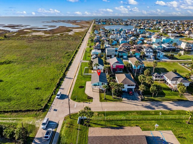 drone / aerial view with a residential view and a water view