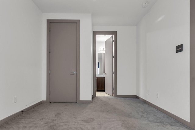 unfurnished room featuring baseboards and carpet floors