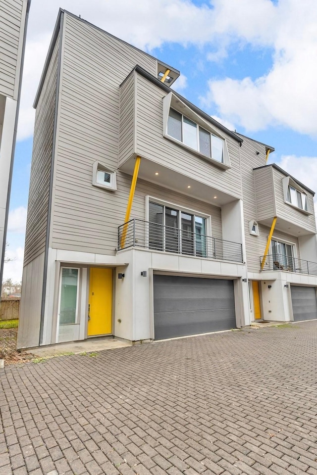 view of front of property with an attached garage and decorative driveway