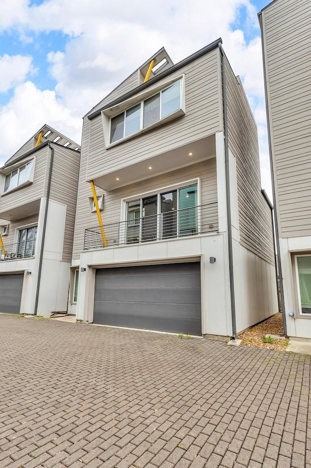 view of front facade with decorative driveway and an attached garage