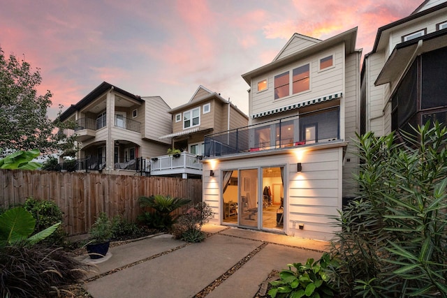 back of property featuring a patio area and fence