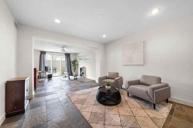 sitting room featuring visible vents, stone tile floors, recessed lighting, and baseboards