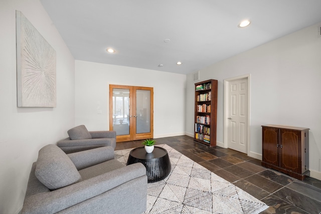 living area featuring visible vents, baseboards, stone tile floors, recessed lighting, and french doors