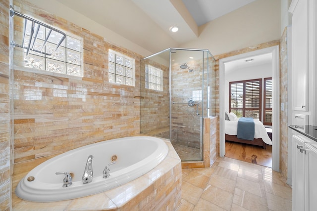 ensuite bathroom with a stall shower, a whirlpool tub, and connected bathroom