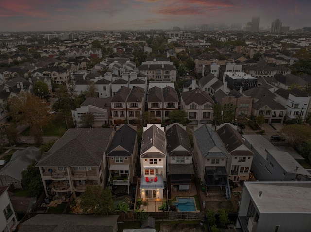 aerial view at dusk featuring a residential view