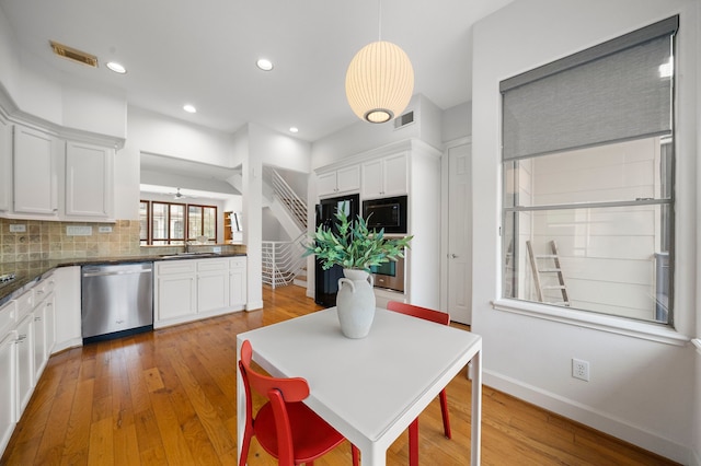 dining space with stairs, recessed lighting, light wood-style floors, and visible vents