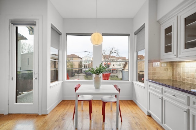 dining room with light wood-type flooring and baseboards