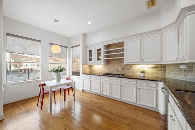 kitchen featuring decorative backsplash, light wood-style floors, visible vents, and stainless steel gas stovetop