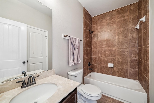 bathroom featuring tile patterned floors, shower / washtub combination, toilet, and vanity