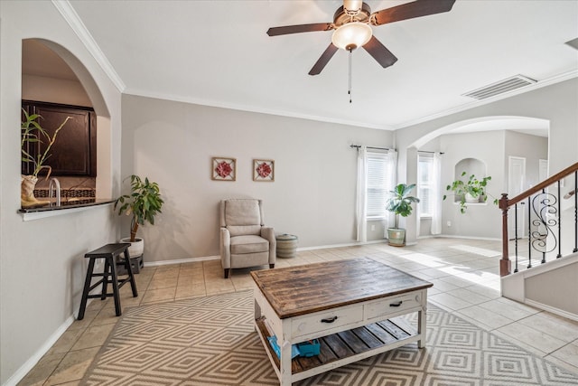 living room with visible vents, crown molding, baseboards, stairway, and light tile patterned floors