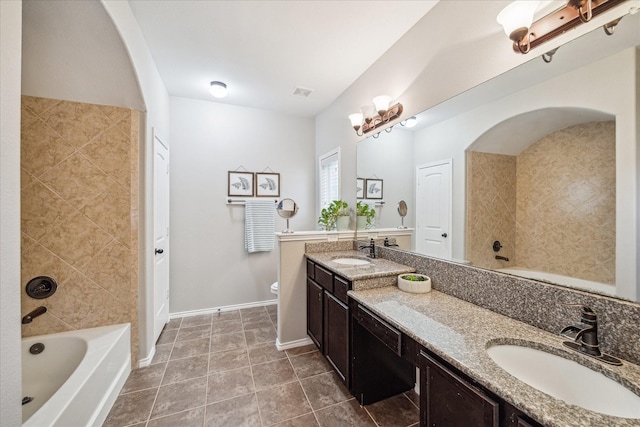 bathroom featuring visible vents, baseboards, toilet, tile patterned floors, and vanity