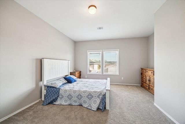 carpeted bedroom with visible vents and baseboards