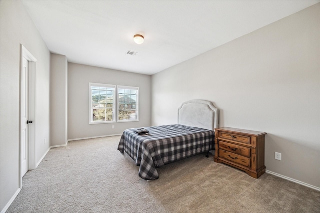 carpeted bedroom featuring visible vents and baseboards