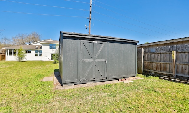 view of shed featuring fence