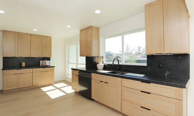 kitchen with tasteful backsplash, dishwashing machine, light brown cabinets, and a sink