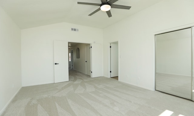 unfurnished bedroom with visible vents, lofted ceiling, carpet, and baseboards