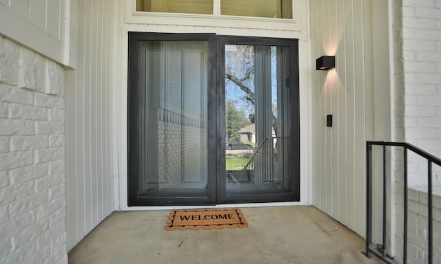 doorway to property with brick siding