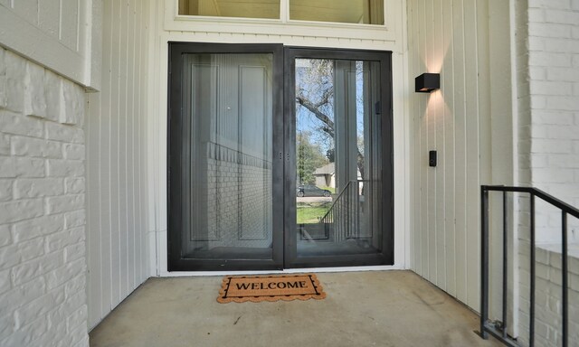 doorway to property with brick siding