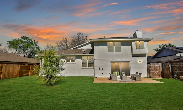 rear view of house featuring brick siding, an outdoor hangout area, a patio, and fence