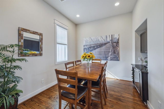 dining space featuring recessed lighting, baseboards, and dark wood finished floors